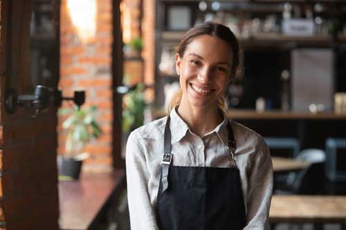 Head-Shot-Portrait erfolgreiche gemischte Geschäftsfrau glückliche Gaststätte oder Cafeteria-Besitzer, die Kamera anschauen, Frau mit Schürze lächelnd Gäste mit florierendem Catering-Business-Konzept